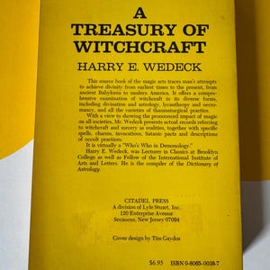 May include: A yellow book cover with the title "A Treasury of Witchcraft" by Harry E. Wedeck. The cover includes text describing the book's content, which explores witchcraft from ancient times to modern America. The book is published by Citadel Press.