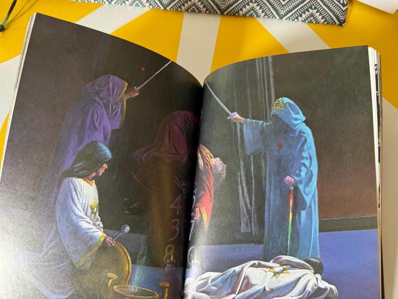 May include: An illustration from a book depicting figures in hooded robes, some holding swords. The figures are in shades of blue, purple, and white. One figure is standing over a person lying on the ground.