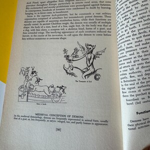 May include: An open book page with text and illustrations about witchcraft. The page features a drawing of a demon playing a trumpet, and another illustration of demons. Text includes "Treasury of Witchcraft" and "Medieval Conception of Demons."