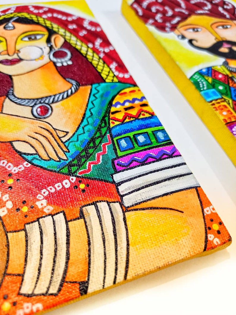 May include: A colorful painting of a woman wearing a red and yellow sari with intricate patterns. The woman has dark hair and is wearing a large, ornate necklace. The painting is done in a vibrant style with bold colors and lines.