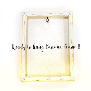 May include: A white canvas frame with a yellow border and a metal hanging ring on the back. The text "Ready to hang Canvas frame!!" is printed on the back of the frame.