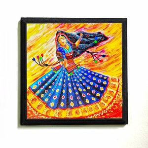 May include: A colorful painting of a woman in a blue and yellow dress with a black veil. The woman is dancing and her dress is flowing in the wind. The background is a yellow and orange sunset.