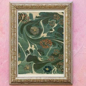 May include: A framed artwork with a gold-colored ornate frame. The artwork features a swirling pattern in shades of teal, green, and white, with accents of orange and blue. The artwork is a decorative piece.