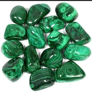 May include: A collection of tumbled malachite stones. The stones are a deep green color with swirling patterns.