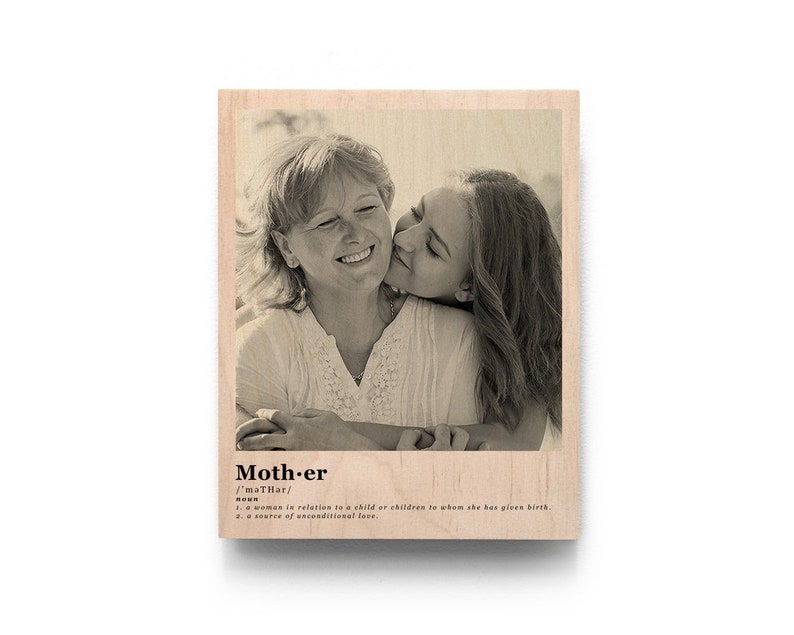 May include: A black and white photo of a mother and daughter hugging and smiling. The photo is printed on a wooden plaque with the word "Mother" and its definition.