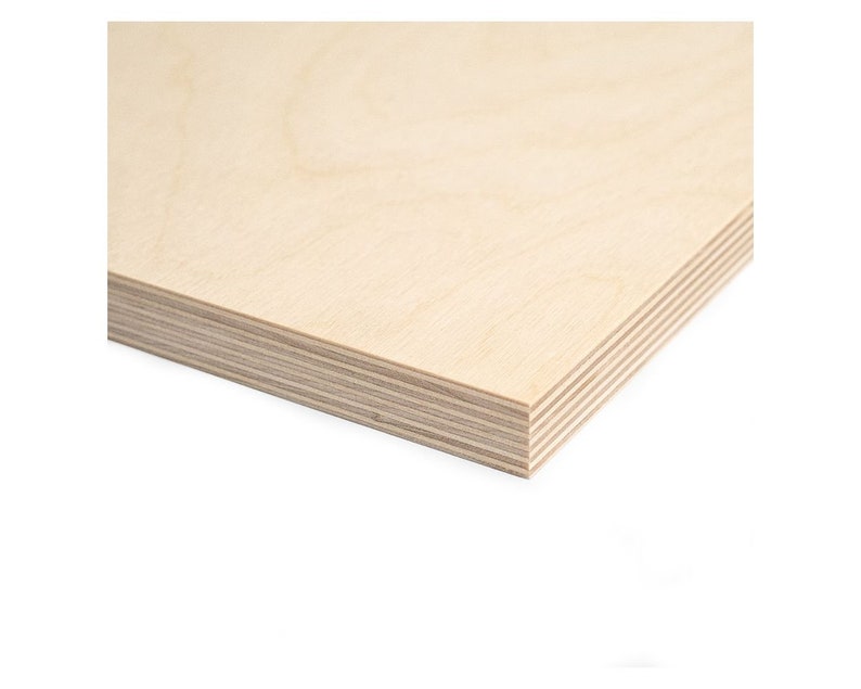 May include: A close-up of a sheet of light brown plywood with a smooth surface and visible layers of wood veneer.