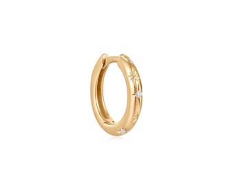 May include: A gold hoop earring featuring a polished finish and a series of engraved starburst motifs. Each starburst design is centered with a small, clear, round-cut gemstone, creating a subtle sparkle along the outer edge of the circular hoop.