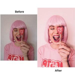 May include: A woman with pink hair is holding a red heart-shaped lollipop in front of her eye. She is wearing a pink shirt with the word "crazy" printed on it.