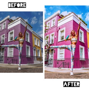 May include: A woman in a colorful patterned sports bra and leggings poses in front of a row of colorful houses. She is holding a blue water bottle in one hand and has her other hand raised in the air. The houses are painted in shades of pink, yellow, and white. The sky is blue and there are clouds in the background.
