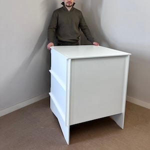 Custom counter top with extra shelf, painted in white, with sticker logo, along carrying bag. 35 inch high