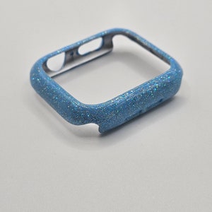 May include: A light blue glitter watch case for an Apple Watch.