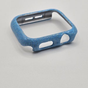 May include: A light blue glitter watch case for an Apple Watch.
