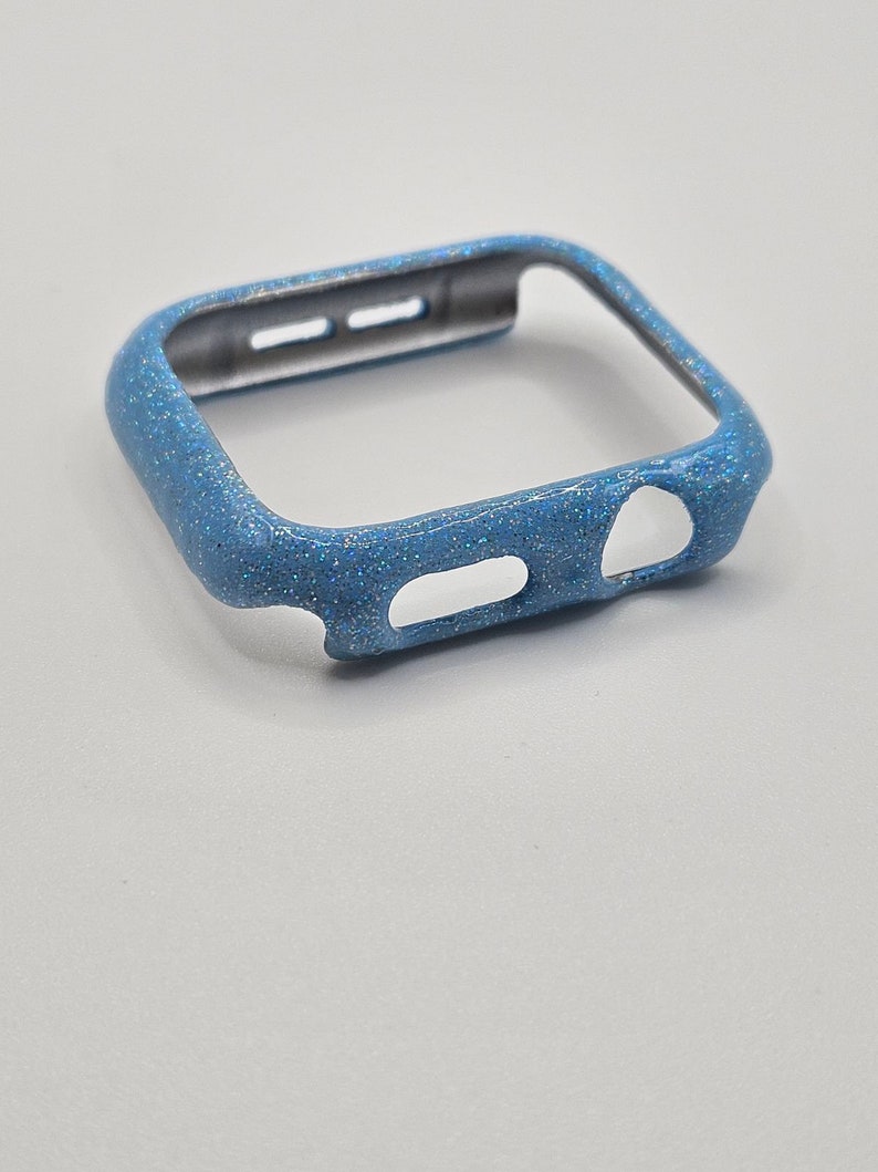May include: A light blue glitter watch case for an Apple Watch.
