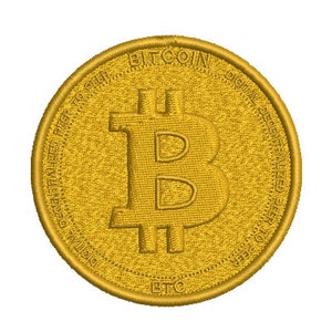 May include: A gold-colored coin with the Bitcoin logo and the text "Bitcoin Digital Decentralized Peer to Peer" around the edge.