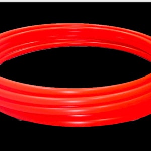 May include: A bright red inflatable pool ring, made of thick, durable plastic. The ring is designed for swimming and water play.