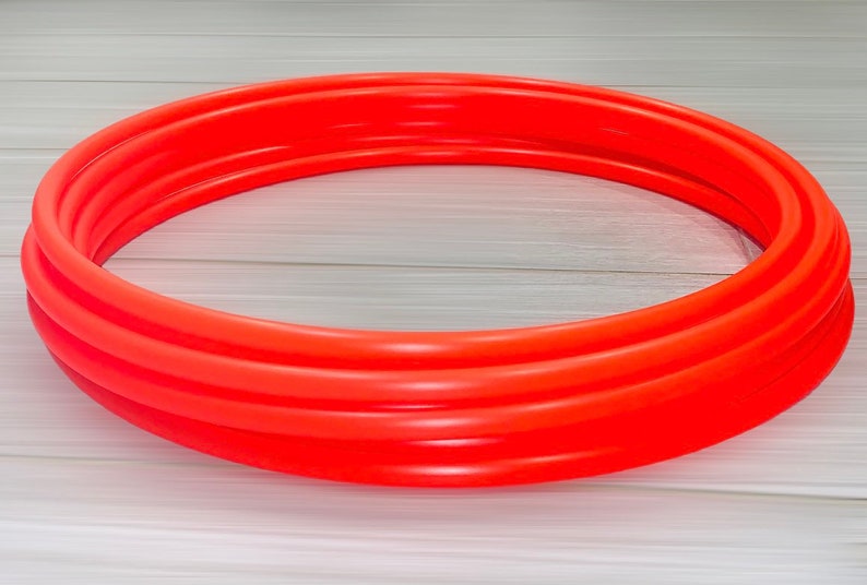 May include: A bright orange inflatable pool ring, made of thick plastic, is ready for summer fun.