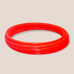 May include: A set of three red plastic hoops, stacked on top of each other.