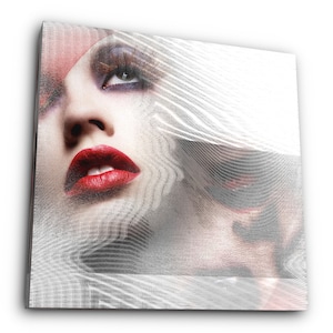 May include: A close-up of a woman's face with red lipstick and dramatic eye makeup. The face is partially obscured by a white, textured, abstract pattern.