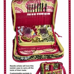 May include: A red and green fabric needle arts case with multiple pockets and compartments. The case is open to reveal a variety of needles and tools. The case is labeled "Case in Point Needle Arts Case".