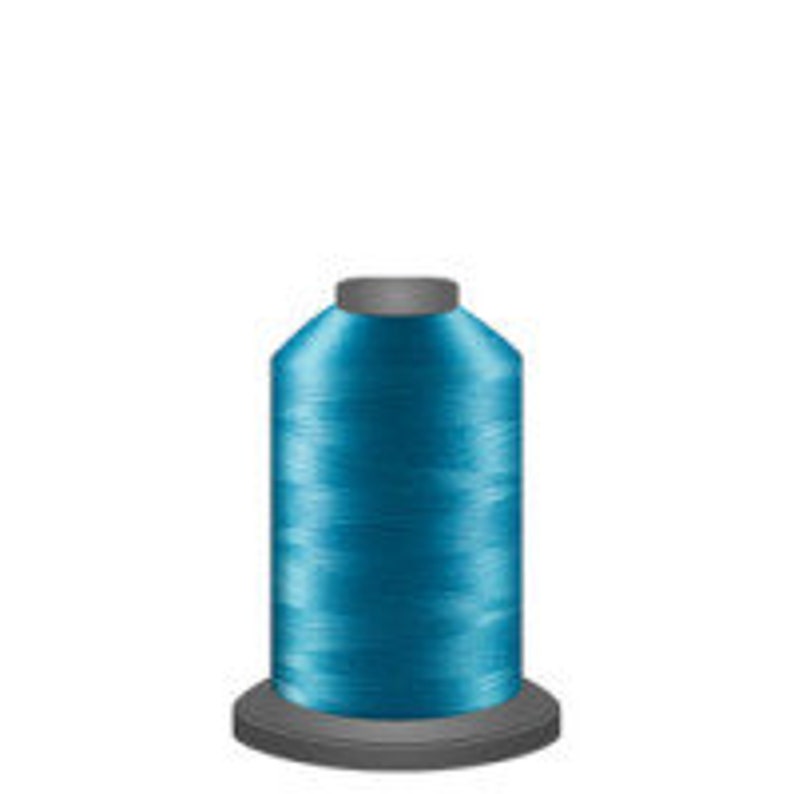 May include: A spool of teal blue thread.