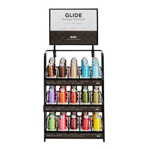 May include: A black metal display stand with three shelves holding spools of Glide Trilobal Polyester thread in various colors. The sign above the stand reads "Glide Trilobal Polyester".