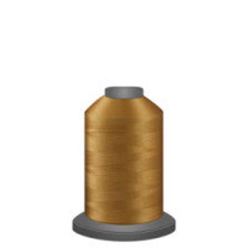 May include: A spool of gold thread for sewing or embroidery.