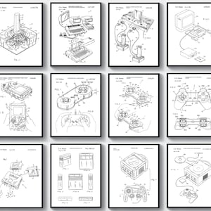May include: A collection of twelve framed black and white patent prints featuring vintage video game consoles and controllers. Each print showcases detailed technical diagrams of classic gaming devices, including joysticks, consoles, and handheld systems.
