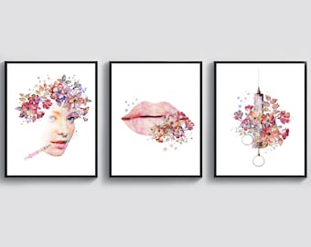 May include: Three watercolor paintings in black frames. The first painting features a woman's face with flowers in her hair and a syringe. The second painting features a pair of lips with flowers. The third painting features a syringe with flowers.