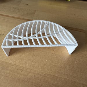 May include: White plastic 3D printed half dome with a lattice design.