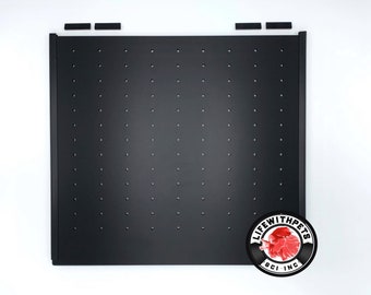 May include: Black metal pegboard with a grid of evenly spaced holes. The pegboard is surrounded by a black frame. The logo "Life With Pets BCI Inc." is printed in white on a black circle with a red betta fish graphic.