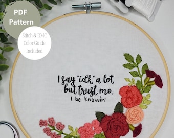 May include: Embroidered hoop art with a floral design in shades of pink, red, and green. The text "I say "idk" a lot but trust me, I be knowin'" is stitched in black thread.