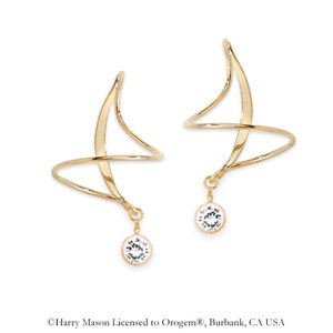 May include: A pair of gold ear cuffs with a dangling crystal. The ear cuffs are made of a thin, twisted wire and have a simple, elegant design.