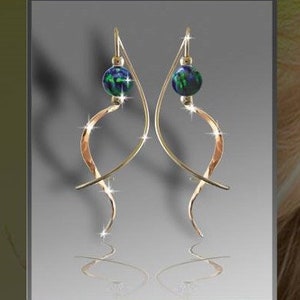 May include: Gold earrings with a hammered finish and a green and blue gemstone bead.