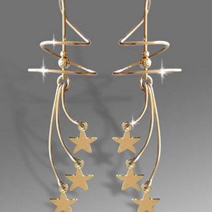 May include: Gold-toned earrings with a spiral design and dangling star charms.