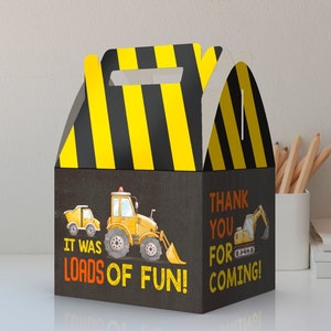 May include: A yellow and black construction themed party favor box with a handle. The box has a picture of a yellow construction truck and the text "It was loads of fun!" on one side and the text "Thank you for coming!" on the other side.