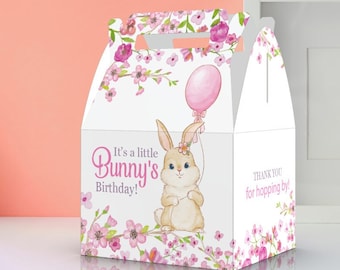 May include: A white favor box with a pink and white floral design. The box features a cartoon bunny holding a pink balloon and the text "It's a little Bunny's Birthday!" and "Thank you for hopping by!"