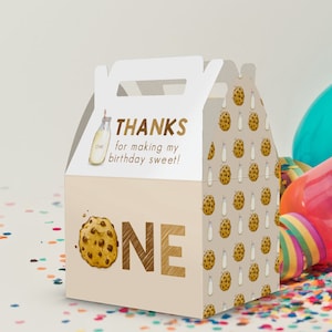 May include: A white favor box with a brown handle. The front of the box has a brown milk bottle with a straw and the text "THANKS for making my birthday sweet!" The side of the box has a brown cookie and the text "ONE". The back of the box has a pattern of brown cookies and milk bottles.