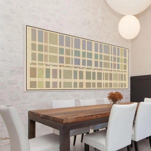 May include: A dining room featuring a rectangular wooden table with a metal frame, surrounded by white chairs. Above the table hangs a large framed abstract artwork with a grid pattern in muted colors. A decorative dried flower arrangement sits on the table.