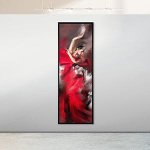 May include: A framed vertical painting depicts a dancer in a flowing red dress. The artwork uses bold brushstrokes and a palette of red, white, and black to convey movement and emotion. The painting is displayed on a white wall.