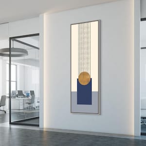May include: Abstract wall art featuring a vertical design with a cream-colored background and black vertical lines. A gold circle and a navy blue square are centered, with a gray rectangle at the bottom. The artwork is framed.