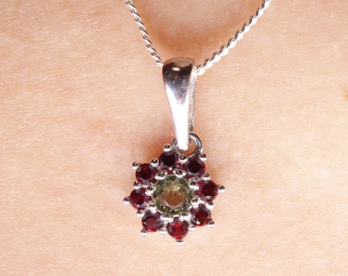 Silver poinsettia flower pendant with natural faceted Czech garnets pyrope and moldavite vltavin 925, 22 K with certificate of authenticity