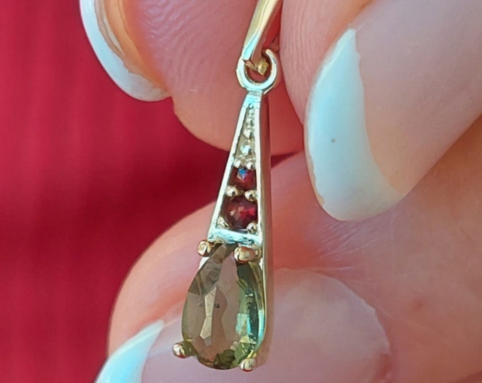 Pendant with faceted Czech moldavite and garnets white and yellow gold 925 Sterling Silver 22 K, 585 White Gold 14 K, 585 Yellow Gold 14 K