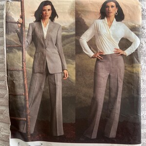 May include: A sewing pattern envelope for an Anne Klein Vogue American Designer suit, pattern number 2759. The front shows two views: a grey blazer with matching trousers and a white long-sleeve wrap top with grey trousers, featuring a barcode.