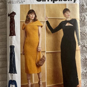 May include: Simplicity sewing pattern R11947 for dresses in sizes 18-26. The package displays two dress variations: a mustard yellow off-the-shoulder midi dress and a long-sleeved black floor-length dress with a cutout neckline detail.