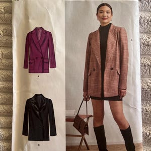 May include: A Simplicity sewing pattern envelope R11941 for a double-breasted blazer. The package displays illustrations of a purple blazer and a black blazer, alongside a photograph of a person wearing a plaid blazer over a black dress.