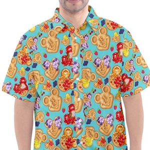 May include: A turquoise blue short-sleeved button-down shirt with a pattern of Mickey Mouse heads made of waffles with fruit toppings.
