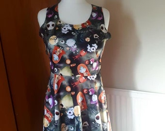May include: A black sleeveless dress with a colorful print of characters from the Nightmare Before Christmas. The print includes Jack Skellington, Sally, and other characters from the movie.