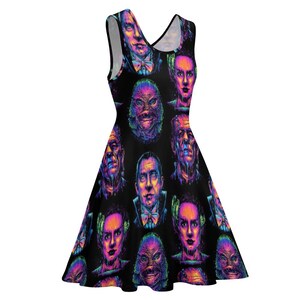 May include: A black sleeveless dress with a colorful print of various monster faces. The print features a variety of colors, including pink, purple, blue, and green.