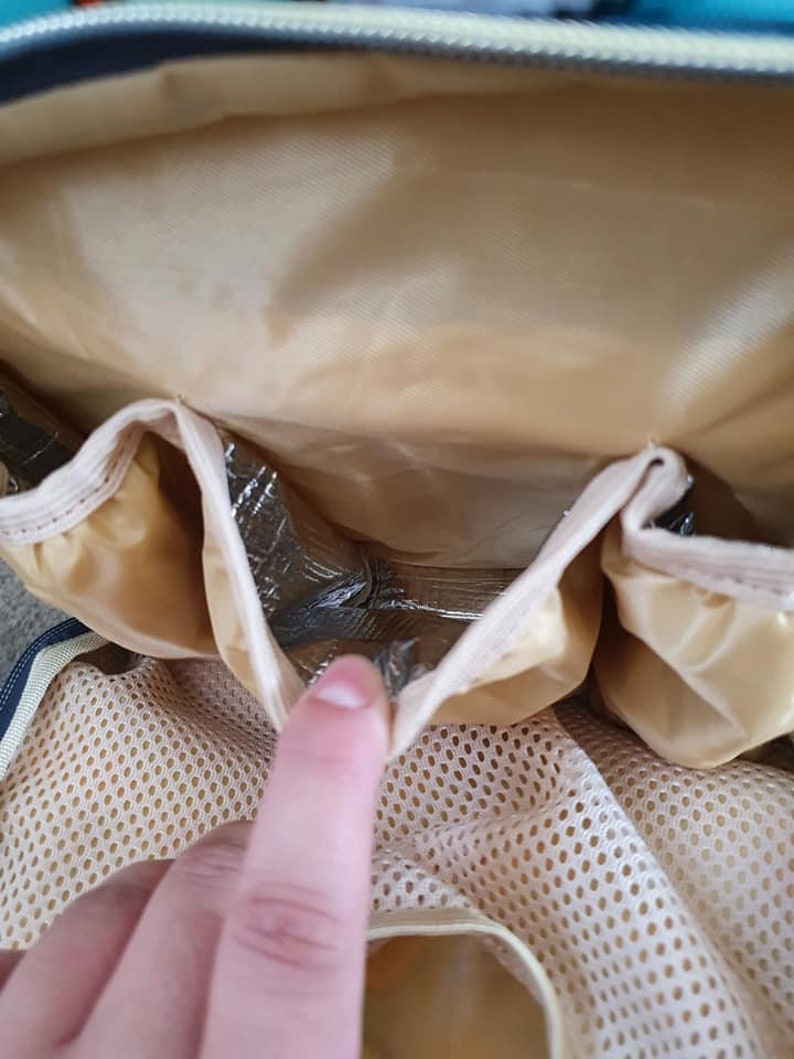May include: A beige diaper bag with a zippered pocket and a mesh pocket. The bag has a silver insulated lining.