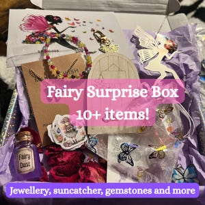May include: A Fairy Surprise Box filled with over 10 items, including jewelry, a suncatcher, and gemstones. The box contains a variety of fairy-themed items, such as a fairy dust bottle, butterfly charms, and a fairy silhouette.